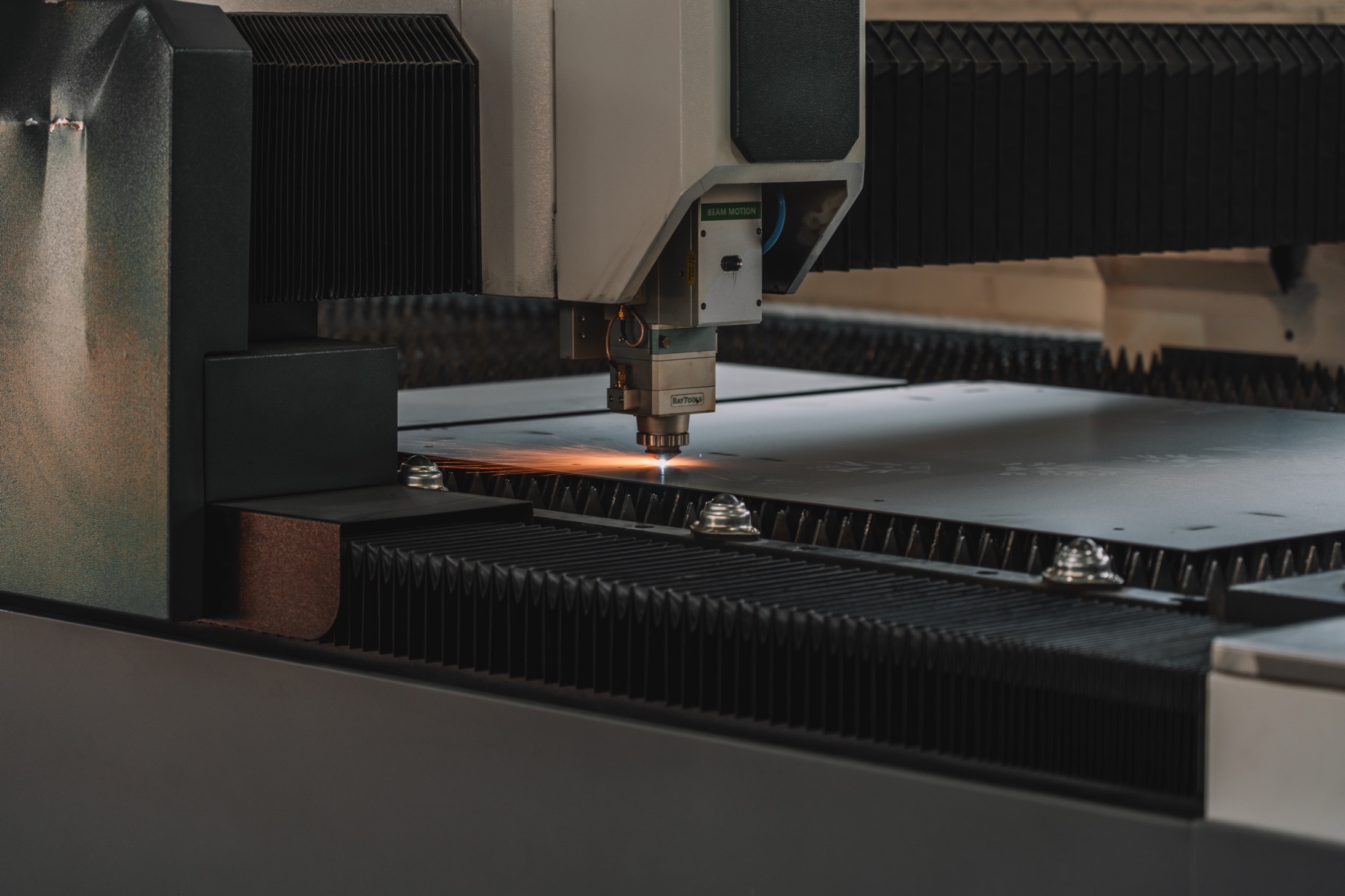 Fibre laser cutting sheet steel for a panel enclosure