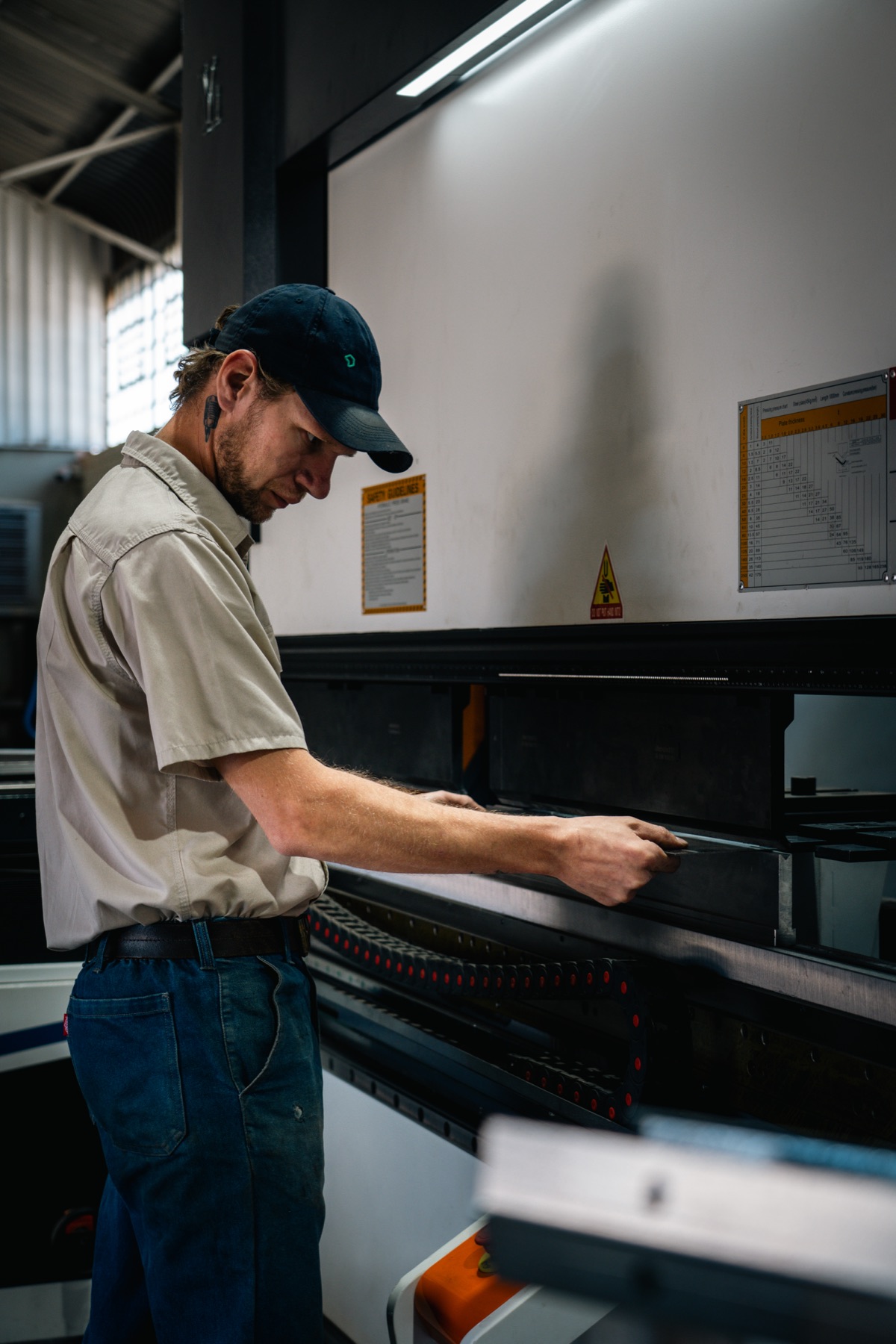 Technician forming a panel enclosure on a press brake