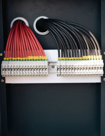 neatly organised electrical wires inside a cabinet
