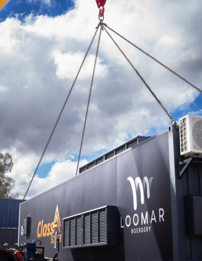 Loomar Boerdery and Class A Solar container being moved by a crane