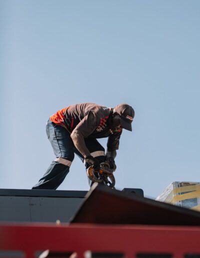 Engineer attaching a crane hook to a container