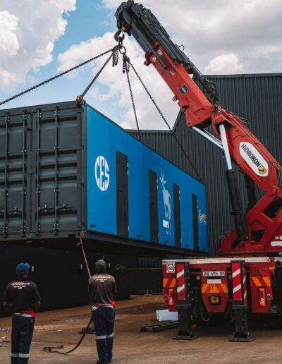 Side-view of a crane moving a container