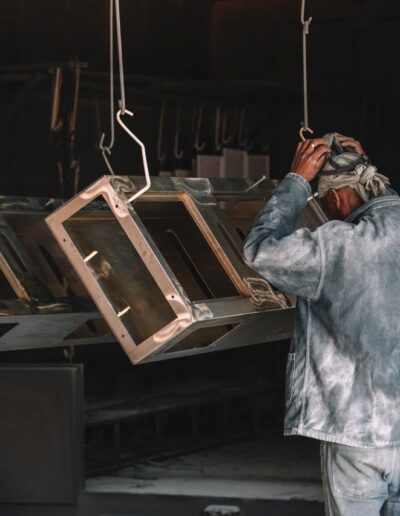 Multiple metal frames hanging to dry after painting