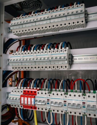 Open industrial electrical cabinet with visible wiring and components.