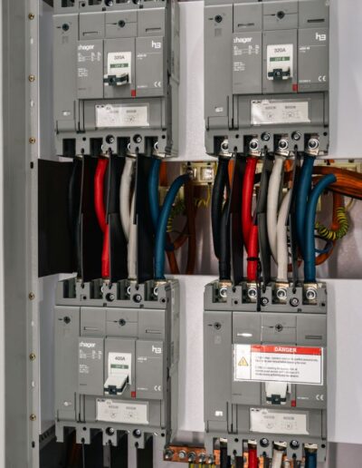 Close-up of colorful electrical wires and circuits inside a control panel.