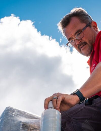Industrialec engineer with a red shirt beneath a blue sky