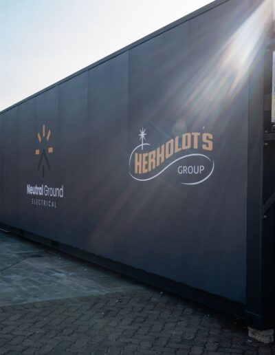 Side-view of a Herholdt's and Neutral Ground Electrical branded Container