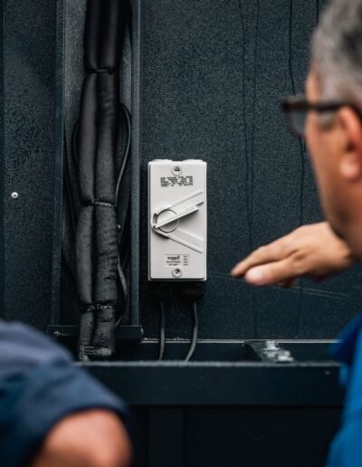Two engineers discussing an enclosed isolator