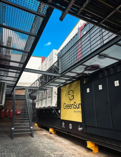 Grated walkway attached to a container