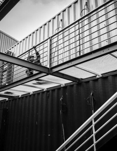 Grated walkways attached to a containerised energy unit