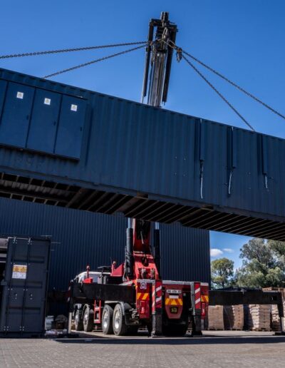 Containerized energy unit being moved by a crane